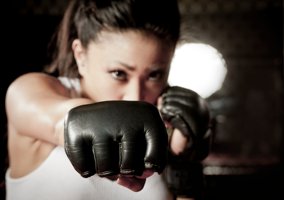 Fierce woman boxer in self defense posture